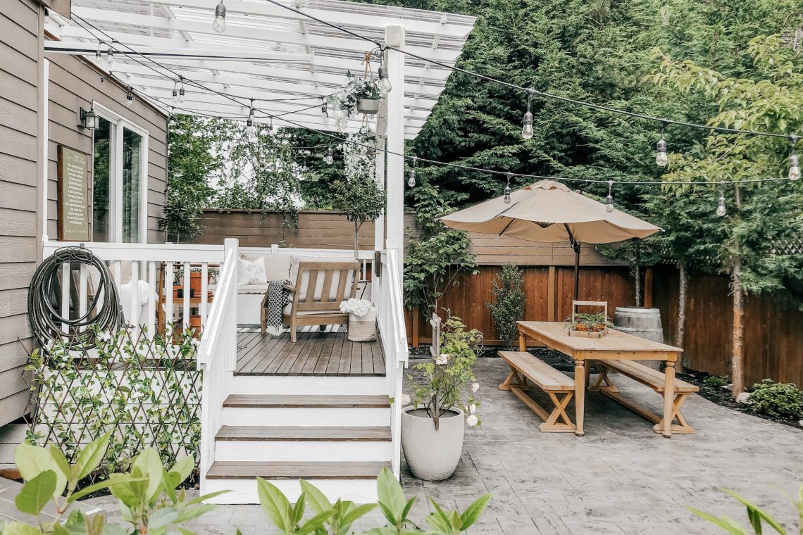 A finished cedar and composite deck with pergola overlooking a Tulsa-area backyard at golden hour